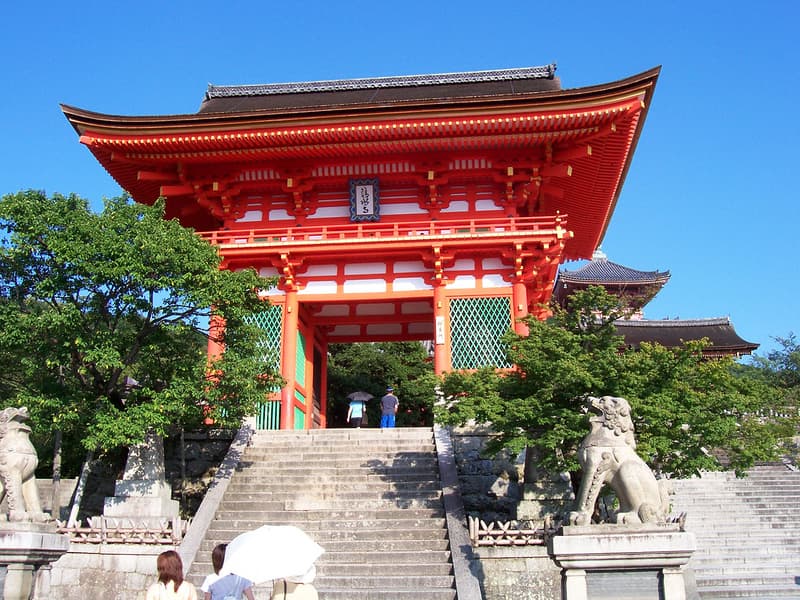 Du khách với ô dù tham quan cổng đá và bậc thềm của Chùa Kiyomizu-dera, Kyoto